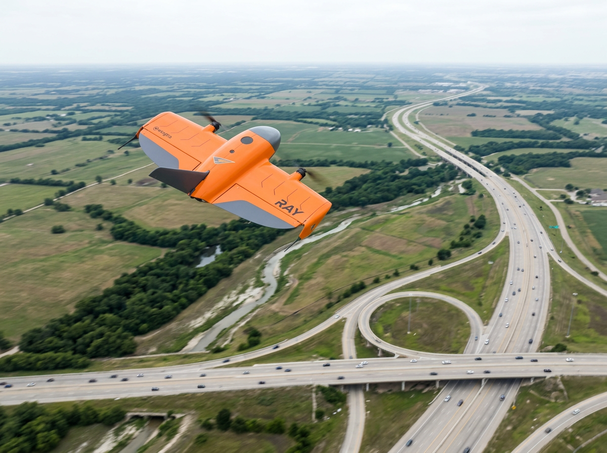 Wingtra Ray VTOL fixed-wing survey drone in flight over a North Texas highway interchange